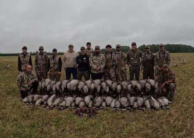 Large hunting group with a big pile of Canada geese